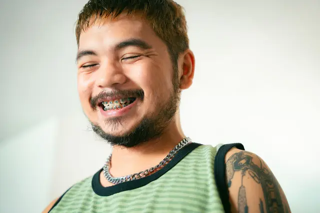 A smiling man with braces