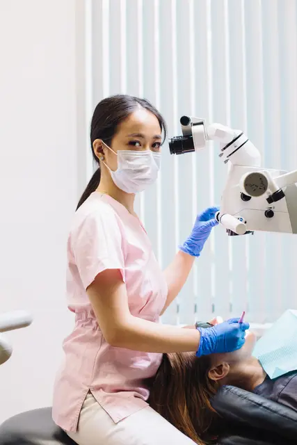 A dentist treating a patient with modern equipment